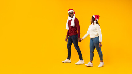 African Couple Wearing Santa Hats Standing Near Free Space, Studio