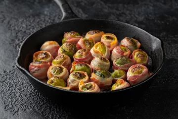 Poster Streaky bacon wrapped Brussel sprouts in cast iron pan © grinchh