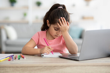 Homeschooling Difficulties. Upset Little Girl Tired Of Doing Homework With Laptop