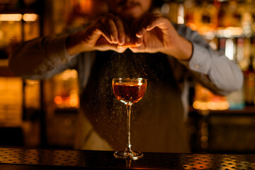 Great front view on wine glass with drink and bartender sprinkles on it