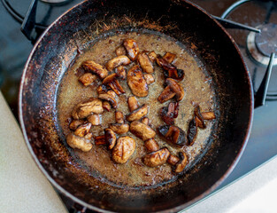 beautiful fried mushrooms champignon in background cast iron pan