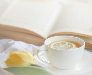 mug of hot tea and book