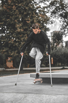Disabled guy jumping on skateboard from springboard