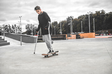 Disabled guy riding skateboard in park