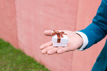 Unrecognizable man hiding ring box