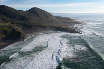 Fototapeta premium The cold Pacific Ocean washes onto the rugged coastline of Northern California north of Fort Bragg. The Pacific Coast Highway runs right along this scenic region in Mendocino County.