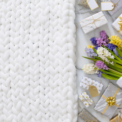 Top view trendy composition with festive wrapped gift boxes ribbon bow decorated by bloom flowers