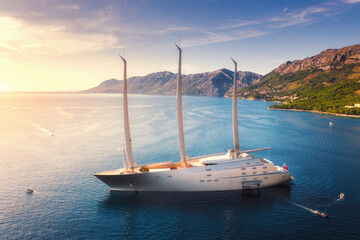 Luxury yacht and blue sea at sunset in summer. Aerial view