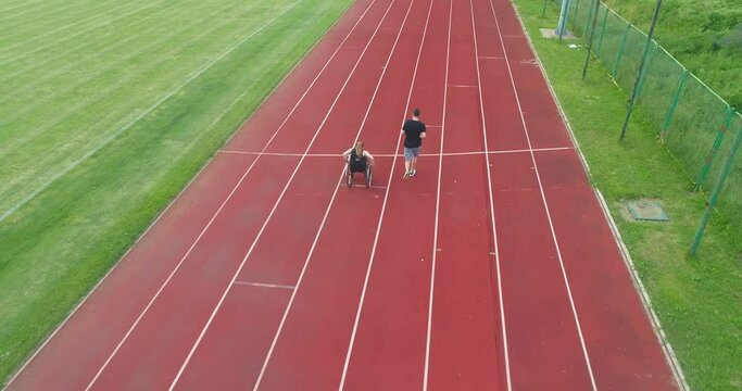 Hero portrait shot of disabled sport people on athletics sports track. 