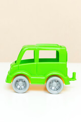 green little car toy on white backgound as a gift for kids. baby's stuff with copy space