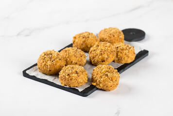 Energy peanut cookies on a serving board on a white background