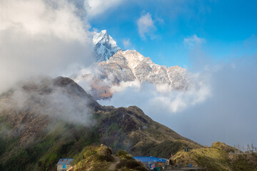 Mountain landscape. Mount Machapuchare (Fishtail) and guest houses on the Mardi Himal trek. Nepal, Himalayas