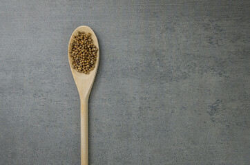 Coriander spice in wooden spoon