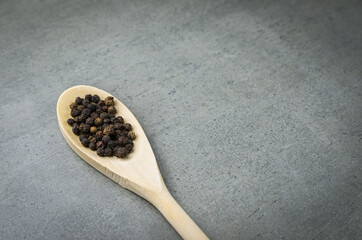 Fototapeta na wymiar Black pepper spice in wooden spoon