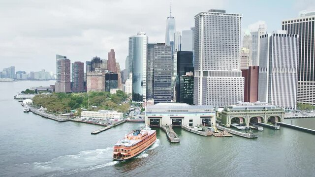 Staten Island Ferry to New York City. South ferry terminal. Aerial Manhattan drone skyscrapers. NYC holidays tourists visit USA, American urban destination. 