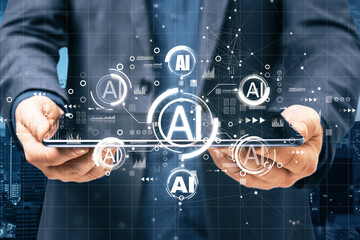 Businessman hand holding tablet with AI hologram on blurry background. Artificial intelligence, ai,...