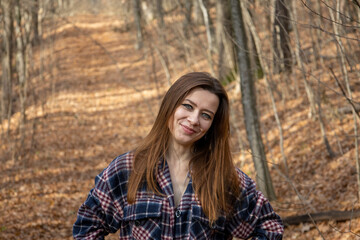Beautiful girl in the woods near the trees