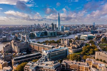 Aerial panoramic scene of the London city financial district with many iconic skyscrapers near river Thames.
