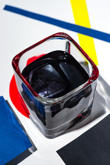 black cocktail in the form of a picture, on a white background, with a frame