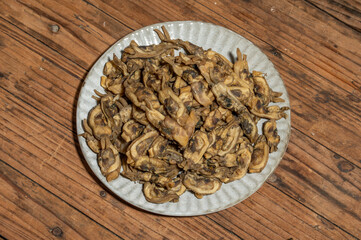 The razor clams in the dishes are dried on the wood grain table