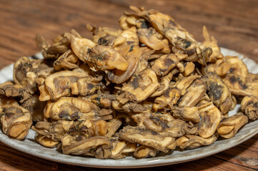 The razor clams in the dishes are dried on the wood grain table