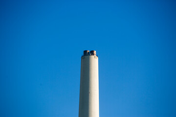 Cooling tower of thermal power plant with blue sky in the background