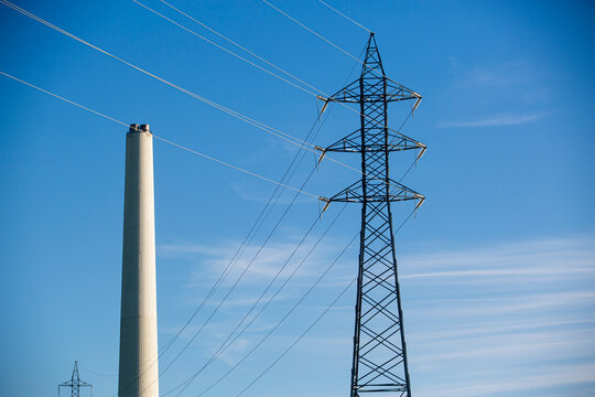 electrical distribution tower with thermal power station chimney next to it