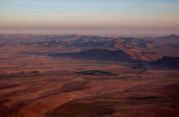 Fototapeta na wymiar The view from a hot air balloon down to the desert and villages near Marrakech, sunrise in April, Morocco