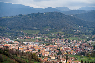 Fototapeta na wymiar Bergamo at the foot of the green mountains. Italy