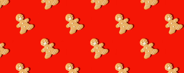 Happy New Year\'s 2022 banner gingerbread man in face mask from ginger biscuits on classic traditional red background, minimal seasonal pandemic winter holiday invitation, seamless pattern