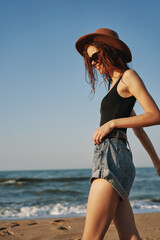 woman in trendy summer clothes by the ocean vacation sun