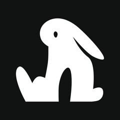 Obraz premium Sitting cartoon bunny. White symbol on black backdrop. Design element