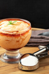 Delicious papaya cream with cassis liqueur, selective focus.
