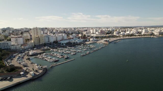 Aerial panorama view Portim&atilde;o Nautical Port on Shore Arade River, Residential Buildings Cityscape