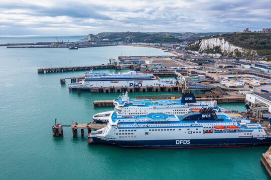 Aerial view of the Dover harbor with many ferries and cruise ships entering and exiting Dover, UK.