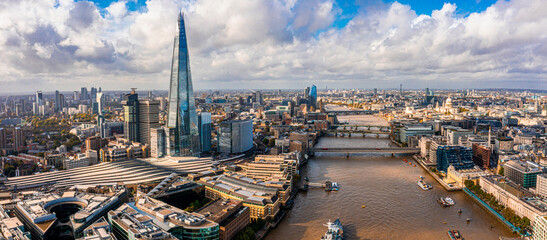Naklejka premium Aerial panoramic scene of the London city financial district with many iconic skyscrapers near river Thames.
