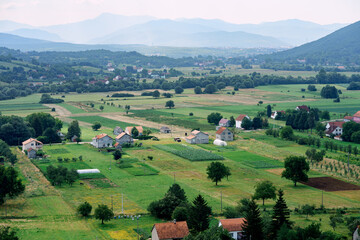 Fototapeta na wymiar Rectangles of fields in a village in the vicinity of Niksic. Montenegro