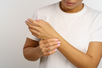 Upset woman hold wrist in pain from using computer or uncomfortable mouse. Female suffer from...