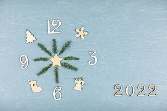 Christmas layout, clock made of wooden numerals with hands of spruce branches, 2022