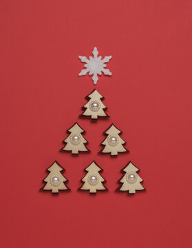Creative image of a fir tree made of small figures with a snowflake on top. The minimum concept of the New Year. Christmas tree.