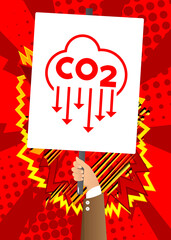Hand holding banner with CO2 emission sign, Carbon dioxide icon on white paper. Man showing billboard.