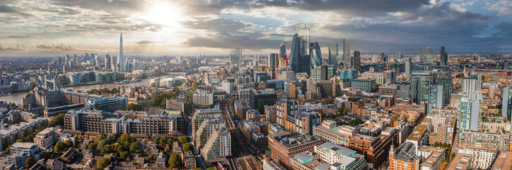 Aerial panoramic scene of the London city financial district with many iconic skyscrapers near river Thames.