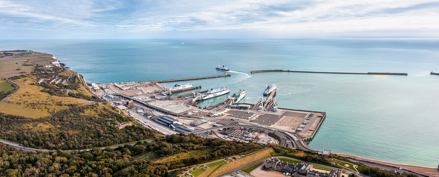 Aerial view of the Dover harbor with many ferries and cruise ships entering and exiting Dover, UK.