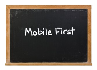 Mobile First written in white chalk on a black chalkboard isolated on white