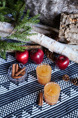 Apple spiced cider served on ice with apple and cinnamon