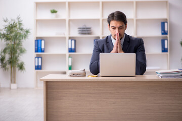 Young male employee working in the office