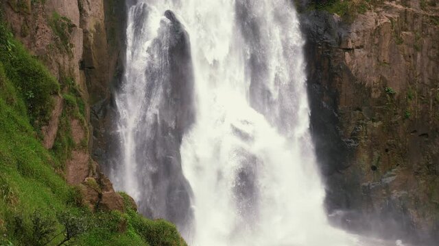 Close up of waterfall in green wild tropical forest in National Park. Tropical mountain landscape of water waterfalls river flow. Rocks with moss and roaring stream. Haew Narok waterfall in Thailand