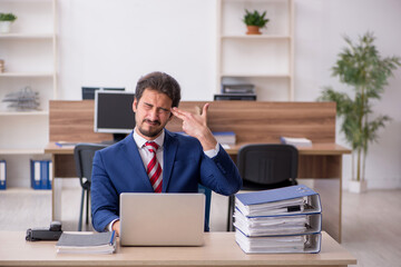 Young male employee working in the office