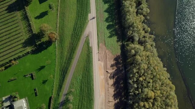Aerial drone view over the beautiful road revealing the beautiful lake and greenhouses in the Netherlands, Europe.