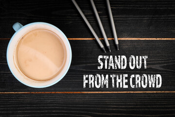 Stand Out From the Crowd. Coffee mug on a dark textured wooden background
